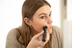 Lady Applying Liquid Foundation